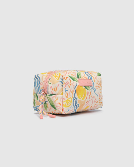 Multicolored cosmetic bag with floral and lemon design on a light gray background