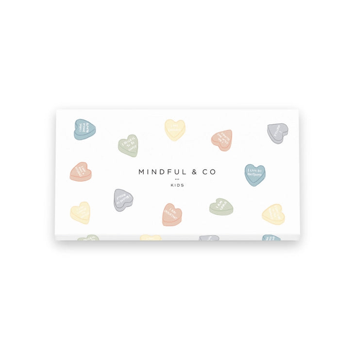 Box of colorful heart-shaped items with 'Mindful & Co' branding on a white background