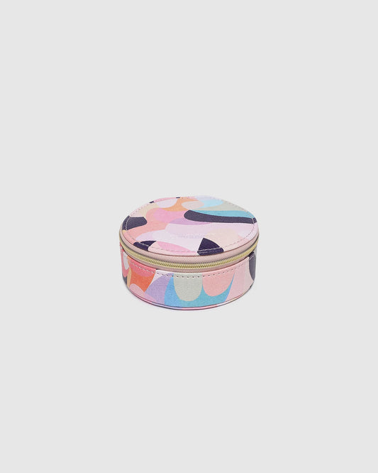 Round pastel-colored cosmetic case on a light gray background