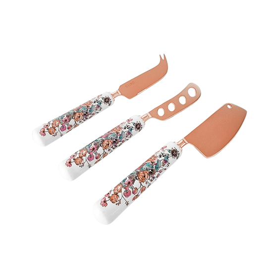 Set of three floral-patterned cheese knives on a white background