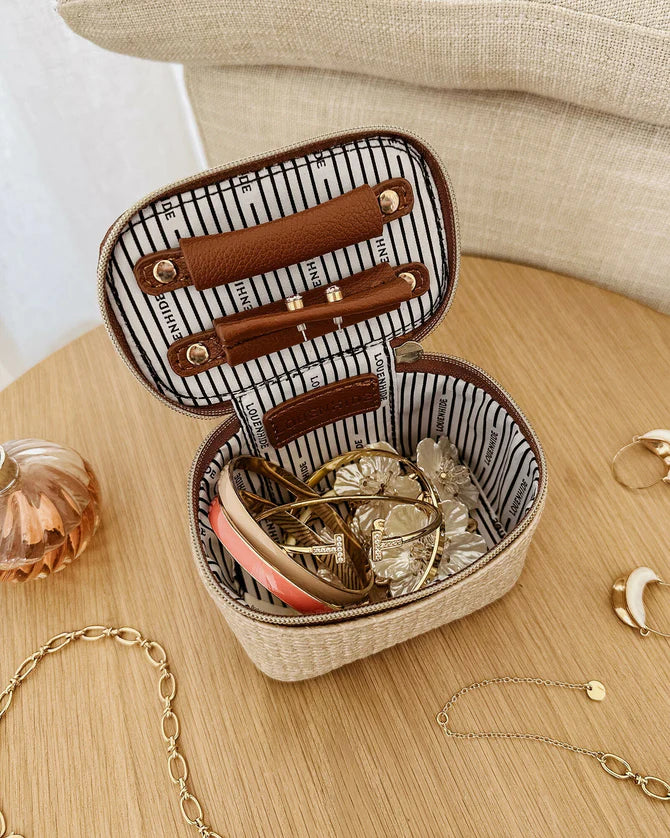 Jewelry case with striped interior on a wooden surface