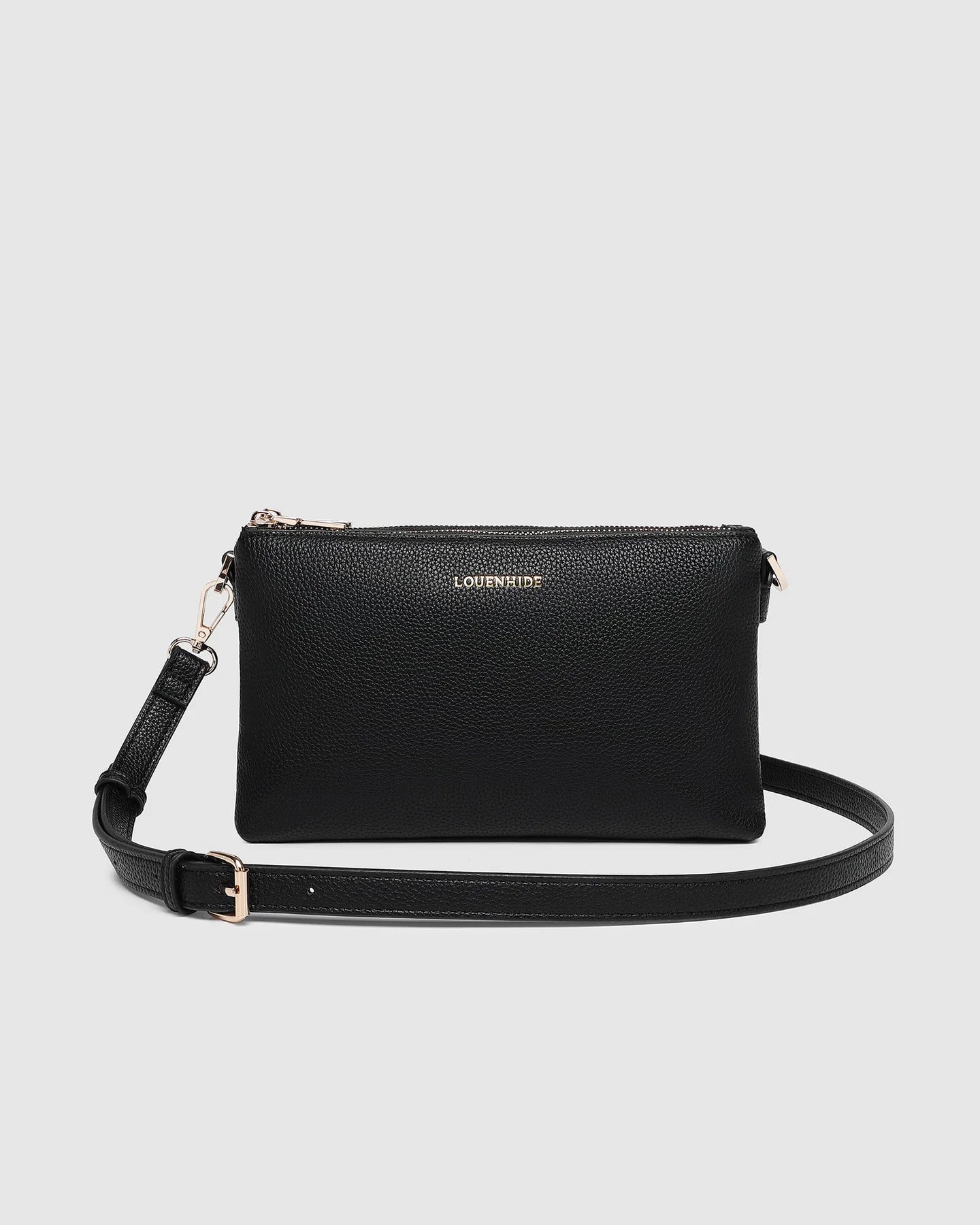 Black handbag with a strap on a light gray background