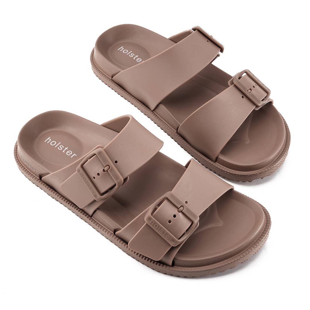 Brown sandals with buckle straps on a white background