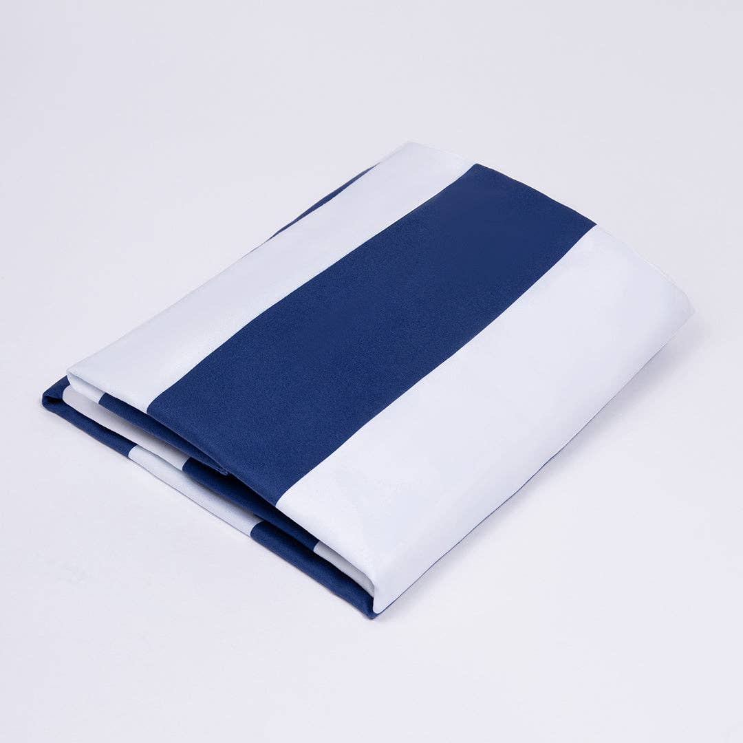 Folded fabric with a blue stripe on a light gray background