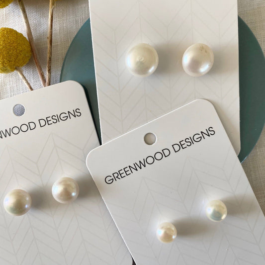 Pearl earrings on Greenwood Designs display cards with a neutral background.