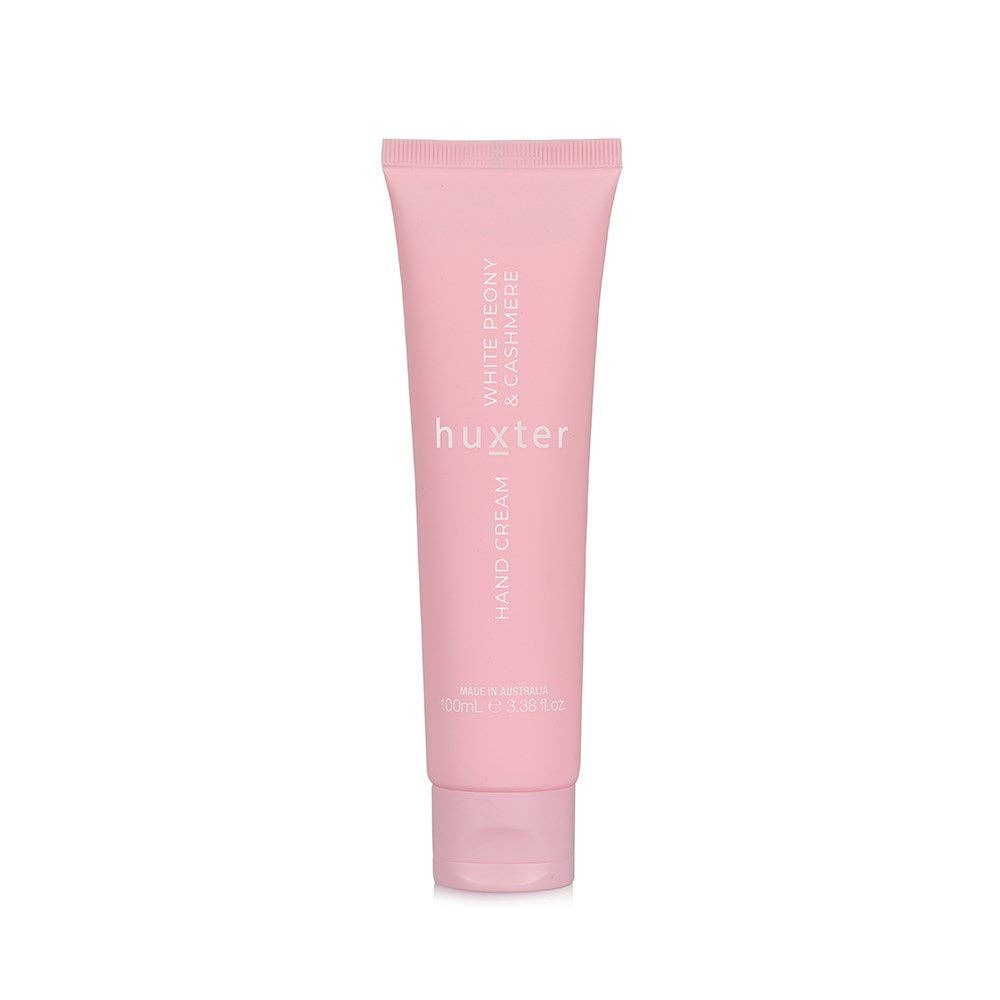 Pink tube of huxter hand cream on a white background