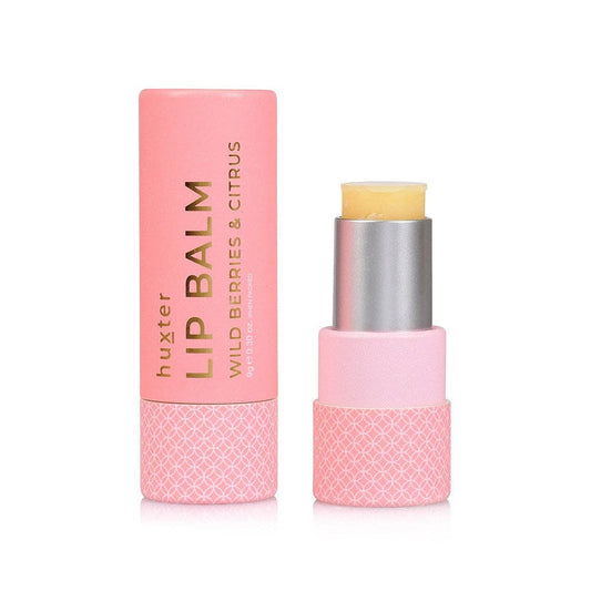 Pink lip balm with silver cap on a white background