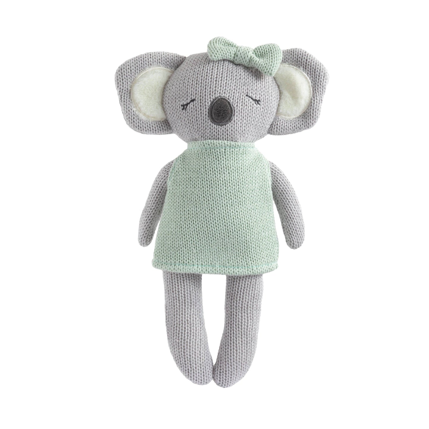 Knitted toy elephant with a green dress and bow on a white background