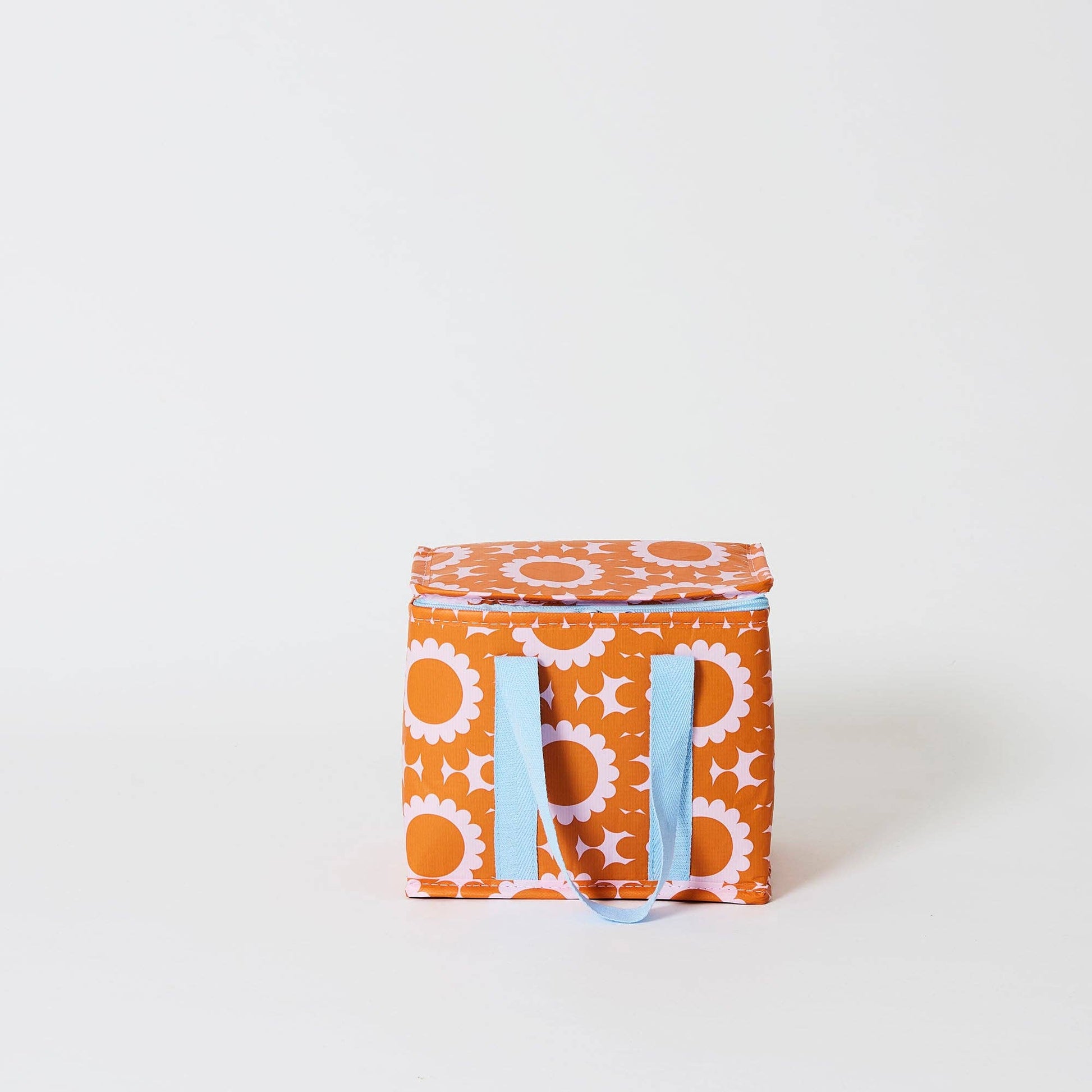 Orange storage box with floral pattern and blue handles on a white background
