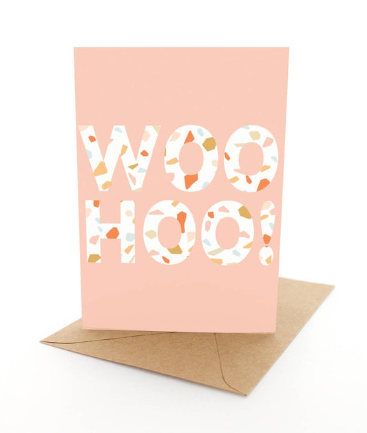 Greeting card with 'WOOHOO!' text on a pink background, featuring a brown envelope.