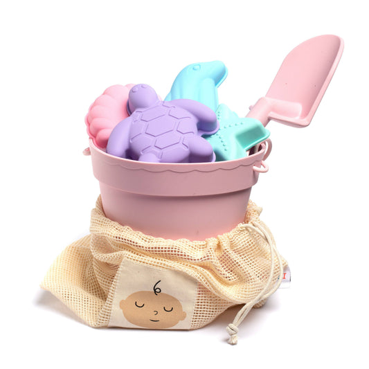 Set of colorful sand toys including a bucket, spade, and molds on a white background.