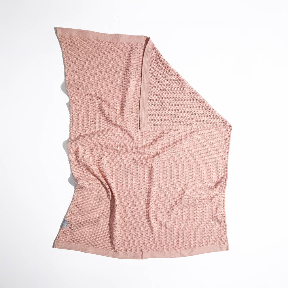 Pink textured blanket on a white background