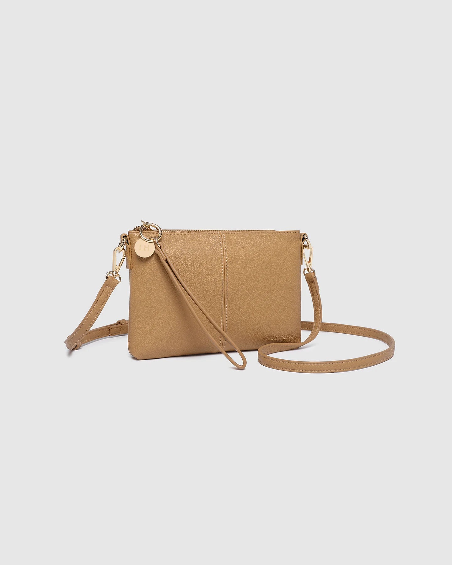 Tan crossbody bag on a light gray background
