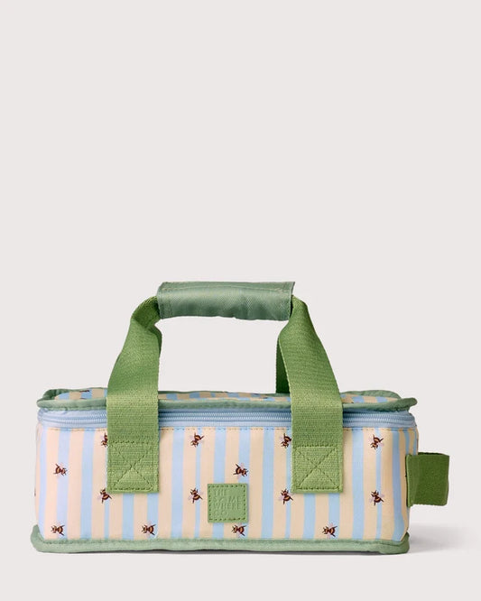A rectangular insulated lunch bag with a light blue and cream vertical stripe pattern, decorated with small embroidered bees, featuring green fabric handles and trim, set against a solid light gray background.