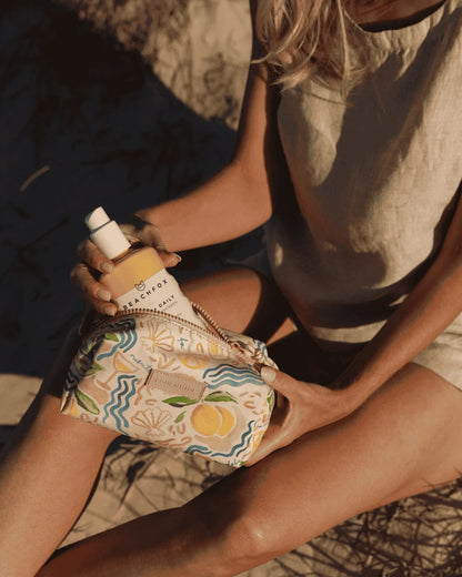 Person holding a patterned bag with a product labeled 'Bach' on a textured surface.