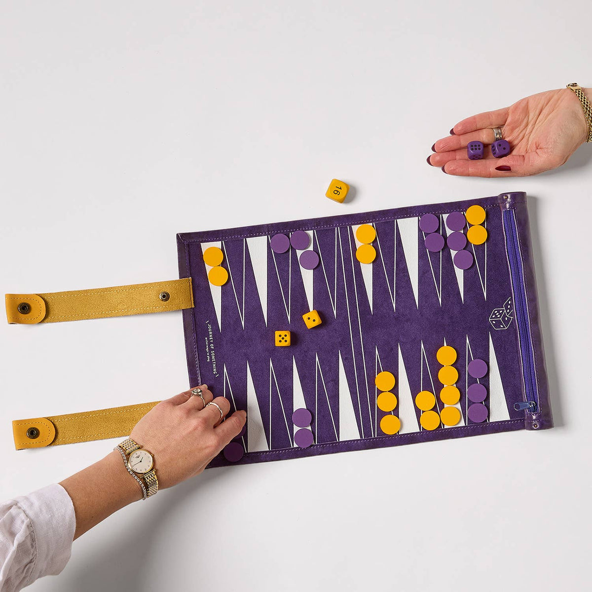 Backgammon board with pieces on a white surface