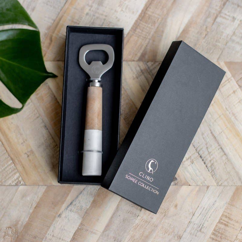 Bottle opener with wooden handle in a black box on a wooden surface