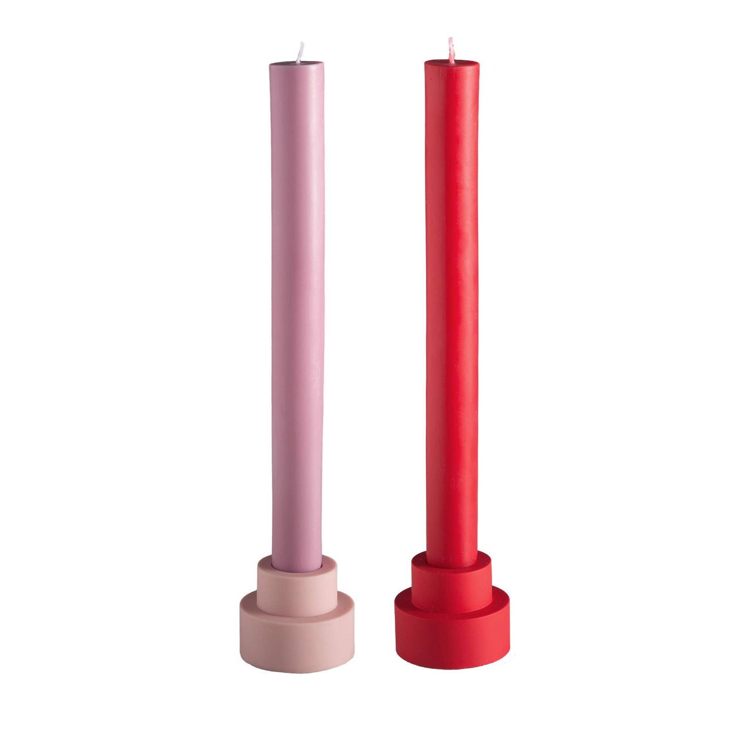 Two candles in pink and red holders on a white background
