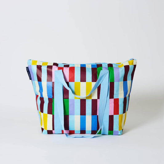 Colorful checkered bag with a blue handle on a white background