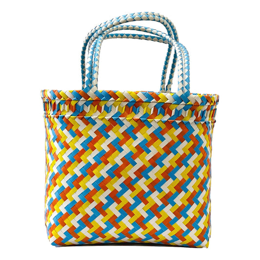 Colorful woven tote bag with a geometric pattern on a white background