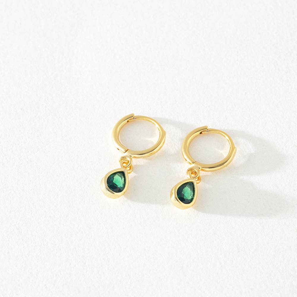 Gold hoop earrings with green teardrop charms on a white background
