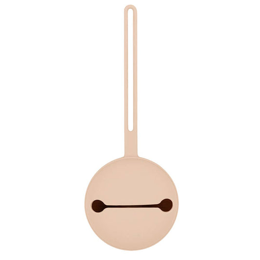 Round beige object with a dark brown line on a white background