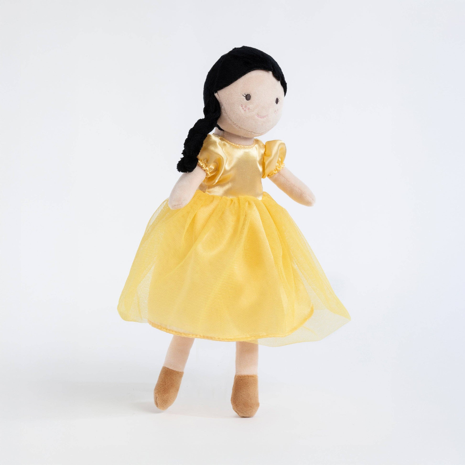 Stuffed doll with a yellow dress on a white background
