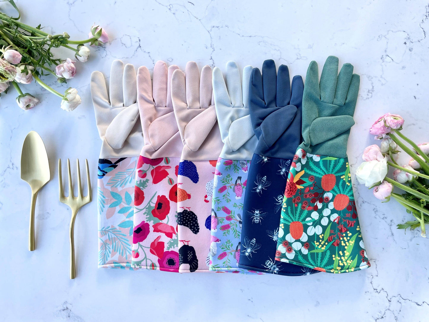 Colorful gardening gloves with floral patterns on a light blue background