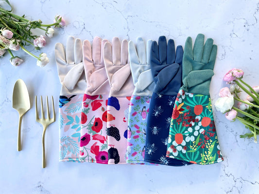 Colorful gardening gloves with floral patterns on a light blue background