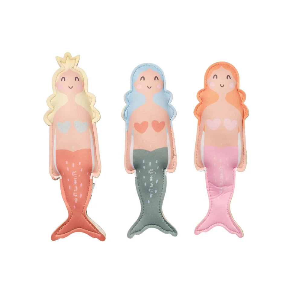 Three mermaid figurines with different colored hair and tails on a white background